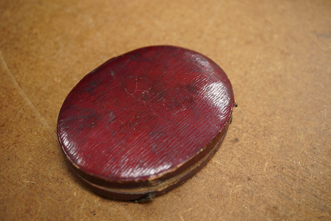 Early 19th century, English School, Portrait miniature of a clergyman, oval watercolour on ivory, housed in a fitted silk and red leather case, 7 x 5.5cm CITES Submission reference, FNKXXK84